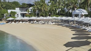 Private beach, white sand, sun loungers, beach umbrellas