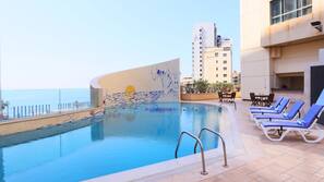 Seasonal outdoor pool, pool umbrellas, pool loungers