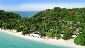 On the beach, white sand, beach umbrellas, beach towels
