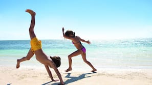 On the beach, white sand, sun-loungers, beach umbrellas