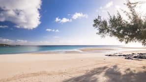 On the beach, white sand, sun-loungers, beach umbrellas
