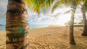 On the beach, white sand, sun-loungers, beach umbrellas