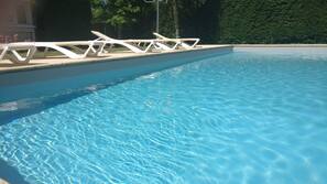 Seasonal outdoor pool, pool loungers