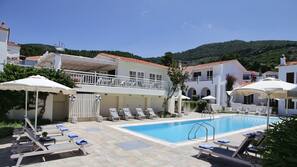 Seasonal outdoor pool, pool umbrellas, pool loungers