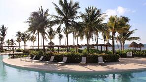 On the beach, white sand, sun loungers, beach umbrellas
