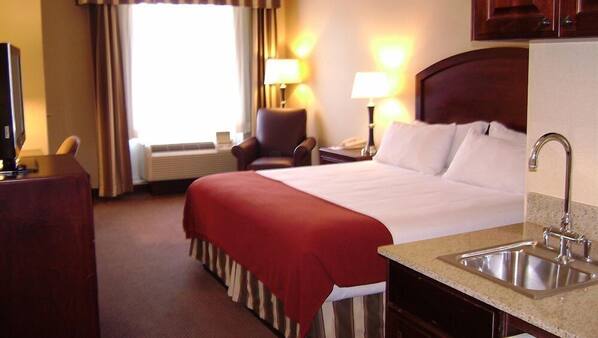 Premium bedding, desk, laptop workspace, blackout drapes