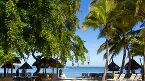 On the beach, sun-loungers, beach umbrellas, beach towels