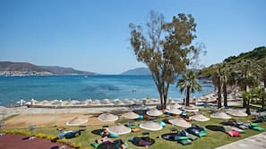 On the beach, sun-loungers, beach umbrellas, beach towels