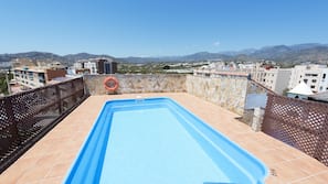 Seasonal outdoor pool, open 10:00 AM to 8:00 PM, pool umbrellas