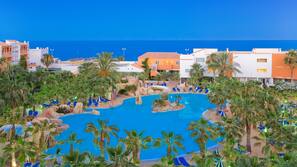 Indoor pool, outdoor pool, pool umbrellas, pool loungers