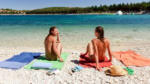 On the beach, sun-loungers, beach umbrellas, rowing