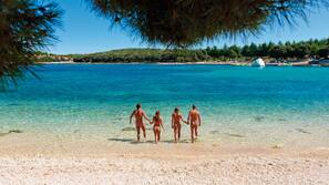 On the beach, sun-loungers, beach umbrellas, rowing