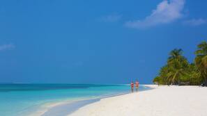 On the beach, white sand, beach towels, waterskiing