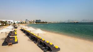 On the beach, white sand, sun-loungers, beach bar