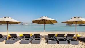 On the beach, white sand, sun-loungers, beach bar