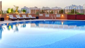Outdoor pool, open 6 AM to 10 PM, pool umbrellas, pool loungers