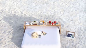 On the beach, white sand, sun loungers, beach umbrellas
