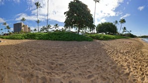 On the beach, white sand, beach cabanas, sun-loungers