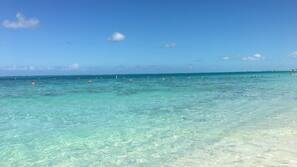 On the beach, white sand, sun loungers, beach umbrellas