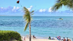 On the beach, white sand, sun loungers, beach umbrellas