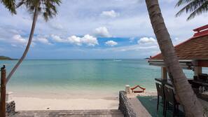 On the beach, white sand, sun-loungers, beach umbrellas