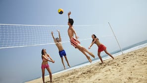 On the beach, beach umbrellas, beach towels, beach volleyball