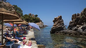 On the beach, sun-loungers, beach umbrellas, beach towels