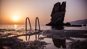 On the beach, sun-loungers, beach umbrellas, beach towels