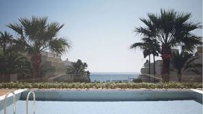 Outdoor pool, open 8 AM to 7 PM, pool umbrellas, pool loungers