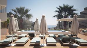 Outdoor pool, open 8 AM to 7 PM, pool umbrellas, pool loungers
