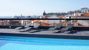 Outdoor pool, open 8:00 AM to 8:00 PM, pool loungers
