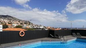Outdoor pool, open 8:00 AM to 8:00 PM, pool loungers