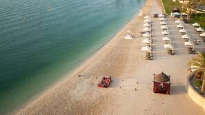 On the beach, sun-loungers, beach umbrellas, beach towels