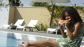 Seasonal outdoor pool, open 10:00 AM to 7:00 PM, pool umbrellas