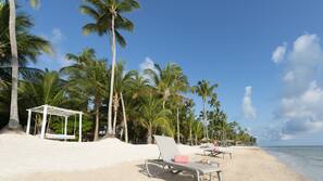 Private beach, white sand, sun loungers, beach umbrellas
