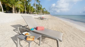 Private beach, white sand, sun loungers, beach umbrellas