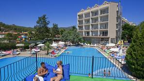 Indoor pool, outdoor pool, pool umbrellas, pool loungers