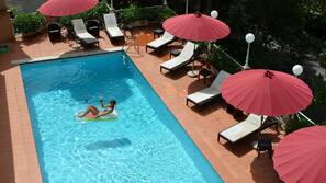 Seasonal outdoor pool, pool umbrellas, pool loungers