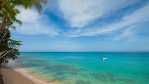 On the beach, white sand, sun-loungers, beach umbrellas
