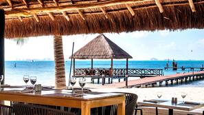 On the beach, white sand, sun-loungers, beach umbrellas