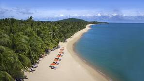 On the beach, white sand, beach umbrellas, beach towels