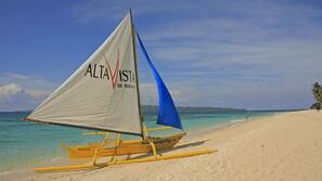 Beach nearby, white sand, beach umbrellas, beach towels