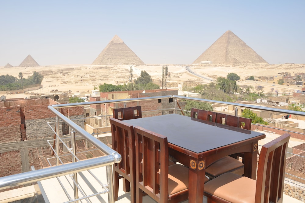The Pyramids of Giza, behind the city of Cairo By Four Seasons Hotel Cairo at Nile Plaza (With
