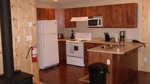 Fridge, microwave, coffee/tea maker, cookware/dishes/utensils
