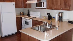 Fridge, microwave, coffee/tea maker, cookware/dishes/utensils