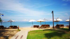 Private beach, white sand, sun loungers, beach umbrellas