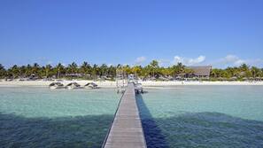 On the beach, white sand, sun-loungers, beach umbrellas