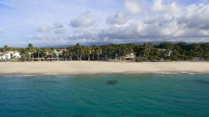 On the beach, white sand, sun loungers, beach umbrellas