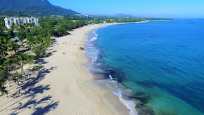 On the beach, white sand, sun loungers, beach umbrellas