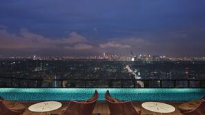 Outdoor pool, open 7 AM to 7 PM, pool umbrellas